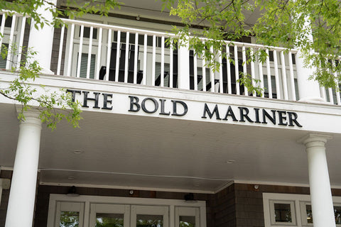 Building with 'The Bold Mariner' sign on a white porch in Norfolk VA