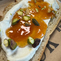 Toast with honey and pistachios on a tray