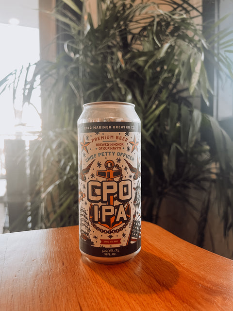 CPO IPA beer can on a wooden surface with a blurred plant background
