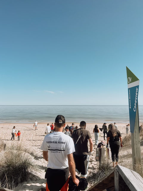 People walking to beach cleanup in Norfolk, VA with Bold Mariner Brewery
