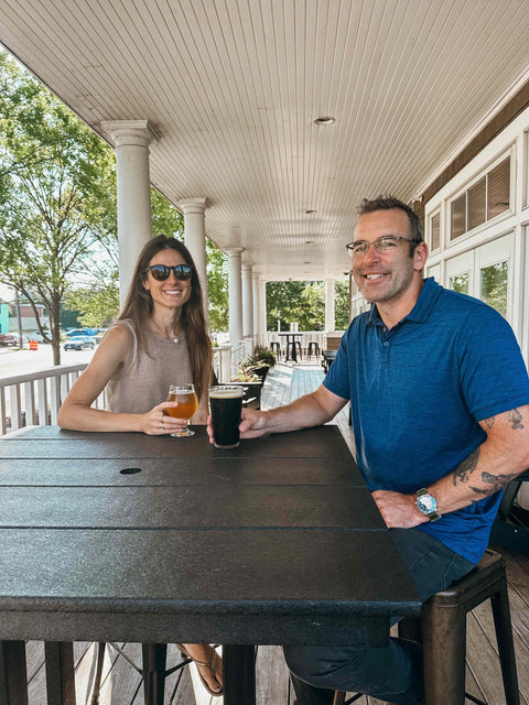 Bold Mariner founders sitting at a table on a porch, enjoying drinks.