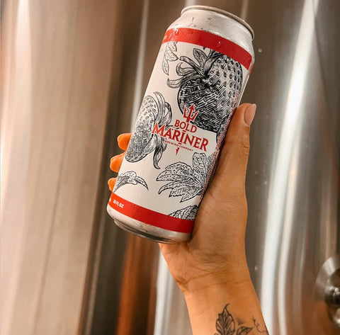 Hand holding a can of 'Bold Mariner' beer with a decorative label.