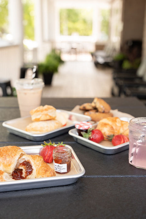 Trays of food on a table with a blurred background