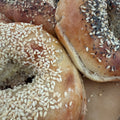 Close-up of bagels with sesame and poppy seeds on a plate