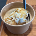 Cup of affogato with a spoon on a wooden surface